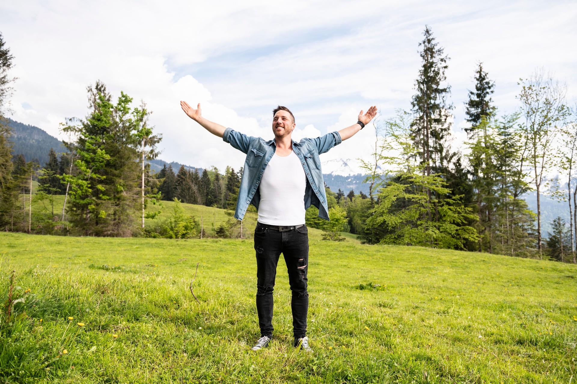 Handsome man with arms wide open