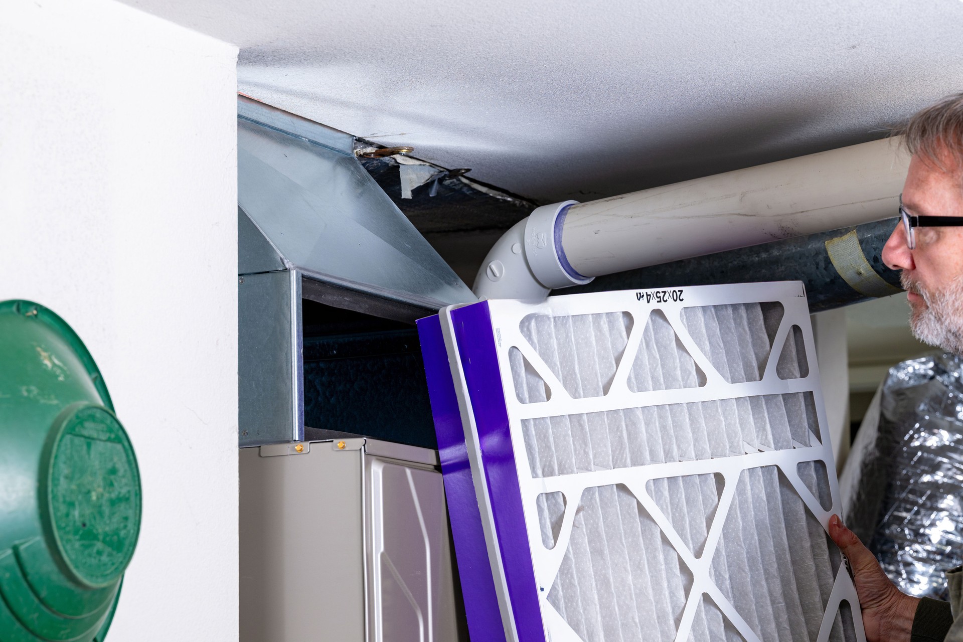 HVAC professional looks at a furnace filter